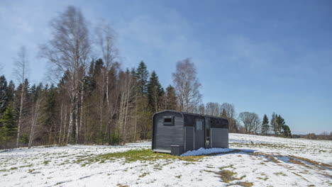 time-lapse of a modern hut, weather and seasons changing on the countryside