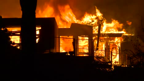 close up of a home burning in a large inferno at night during the 2017 thomas fire in ventura county california 1