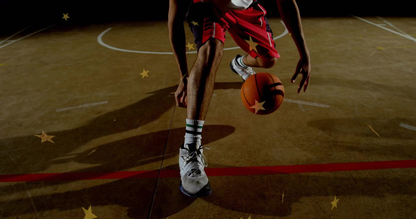 Giocatore di basket che esegue un crossover illuminato da un riflettore, con stelle che inseguono la palla per l'allenamento