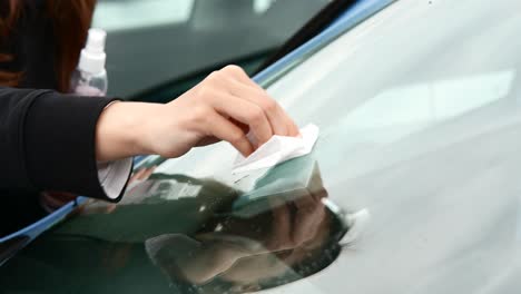 cleaning a car windshield