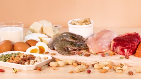 variety of protein-rich foods on orange background