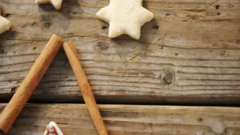 christmas cookies and cinnamon sticks on wooden table 4k