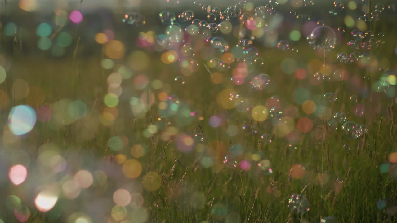 Colorful bubbles floating in the air above a grassy field, creating a dreamy, magical atmosphere. The vibrant bubbles reflect light, adding a touch of whimsy ,playfulness to the serene natural setting