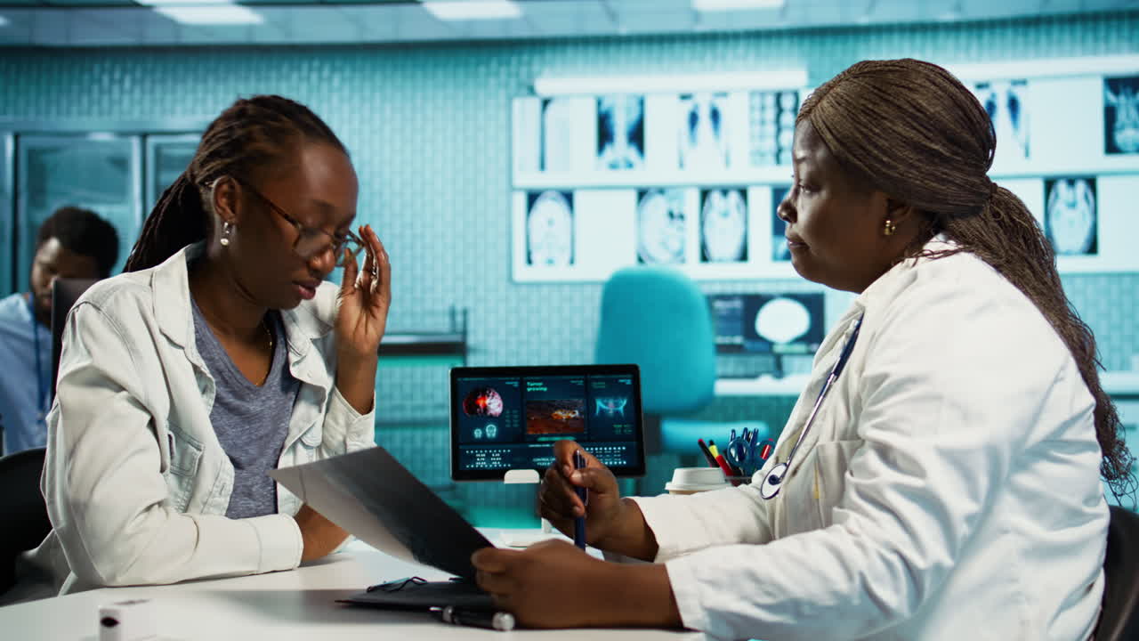 African american female doctor discussing a scary cancer diagnosis with patient