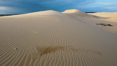 sunset on a cloudy day over the white sand dunes in mui ne vietnam