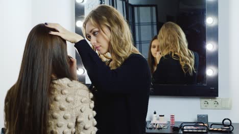 makeup artist young woman's make up in a studio 2