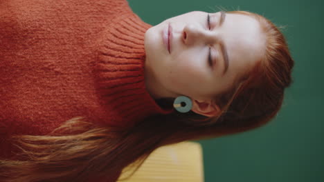 portrait of a woman wearing an orange sweater