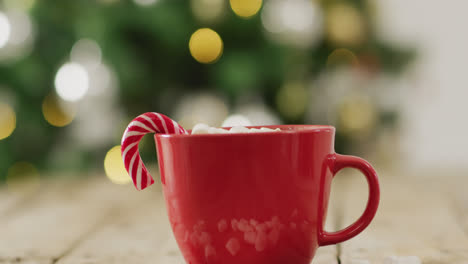 video of cup of hot chocolate with marshmallows over wooden background