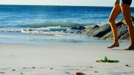 Female-volleyball-player-walking-in-the-beach-4k