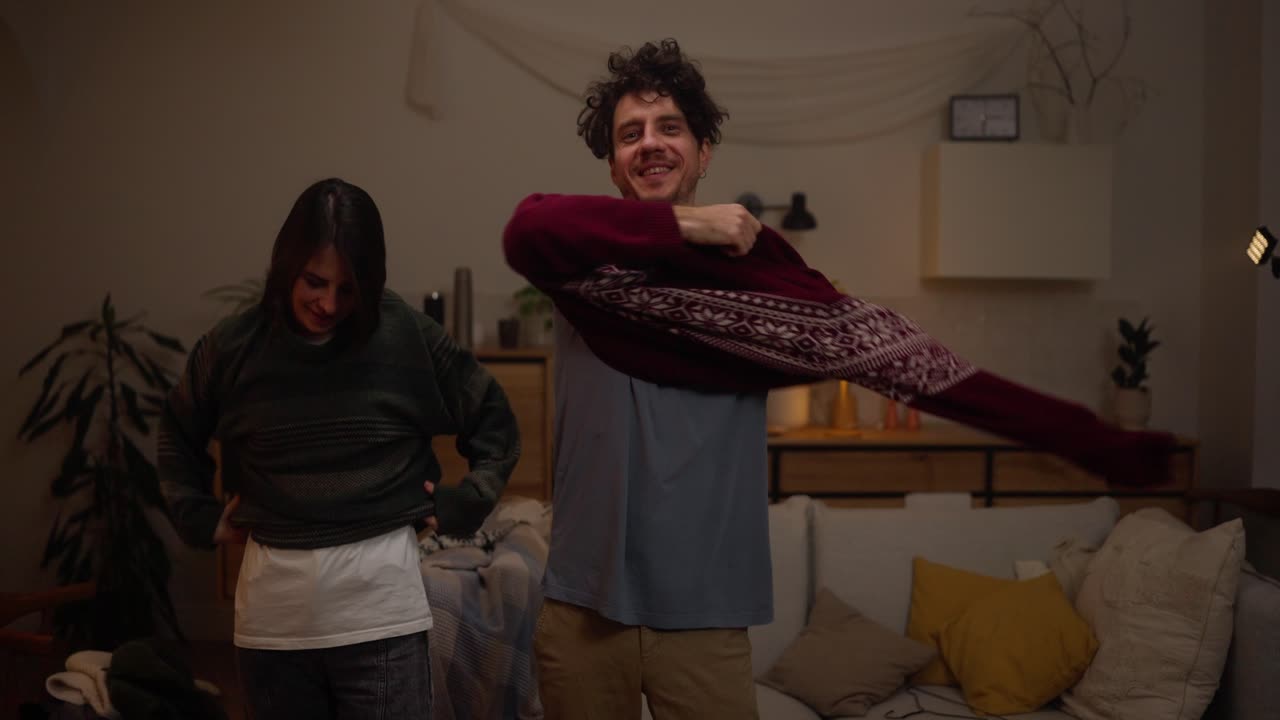 Couple Wearing Cozy Sweaters at Home
