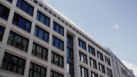 Glass-Front-of-Office-Building-against-the-blue-sky