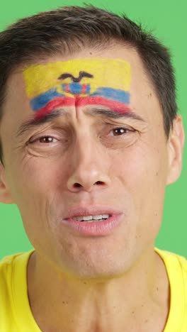 Very nervous man supporting ecuadorian team during a difficult match