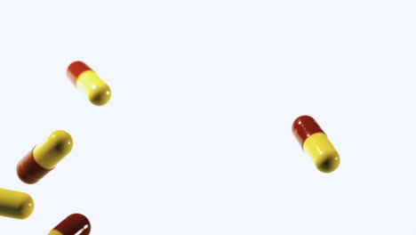 red and yellow capsule tablets dropping and bouncing