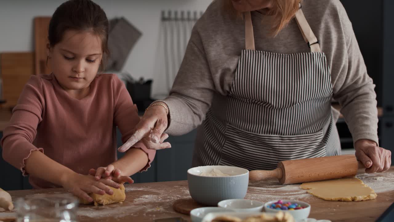 Caucasian girl baking cookies with grandmother