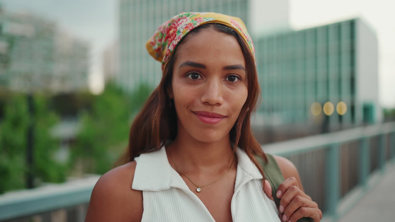 Woman in Headscarf Smiling in Urban Setting