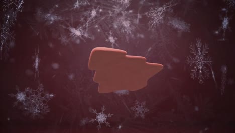 animation of christmas tree gingerbread cookie over snow falling