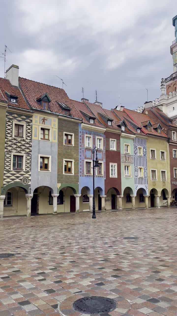 View of beautiful old colourful merchant houses and Poznan Town Hall in Poznan Old Town Main Square on an early morning with no people - newly renovated square, Poznan, Poland
