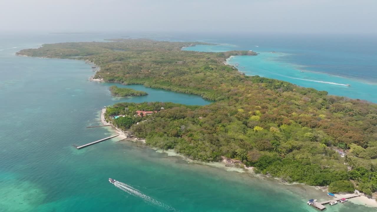 Drone view of Isla Grande in Rosario Islands, Colombia, surrounded by crystal clear Caribbean waters, coral reefs and lush tropical scenery