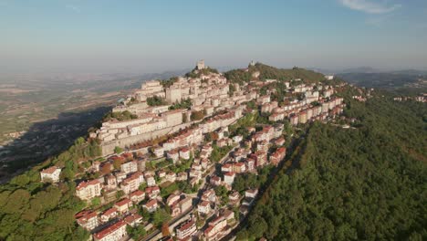 San-Marino,-Italy,-city-on-a-mountain,-city-building,-drone-orbit-view