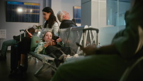 family waiting for flight at airport