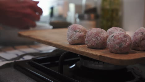 Housewife-preparing-delicious-beef-meatballs-on-kitchen-counter-top