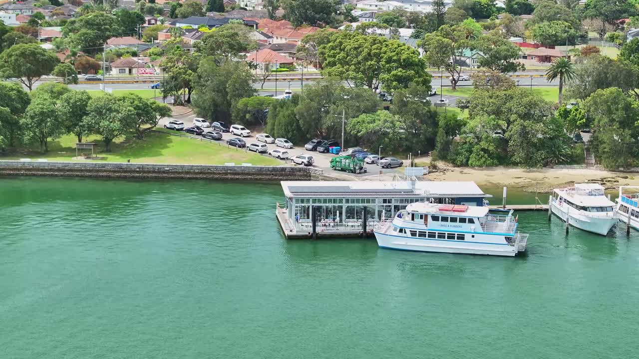 Aerial of a tourist boat docking beside the Bass and Flinders Pavilion at Sans Souci in Sydney Australia