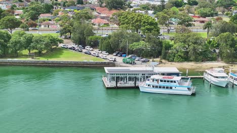 aerial of a tourist boat docking beside the bass and flinders pavilion at sans souci in sydney australia