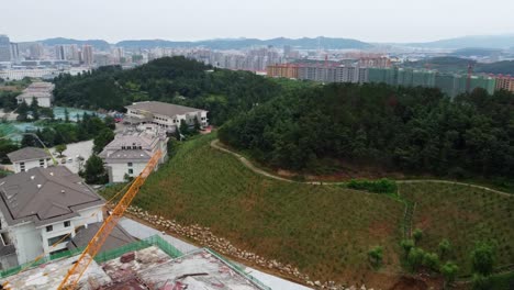 aerial panoramic view of weihai city in china drone revealing skyline cityscape of chinese modern area under construction with crane