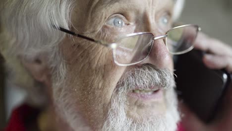 gray-haired senior man talking on phone