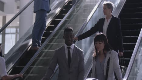 businesswoman using escalator in a modern office 4k