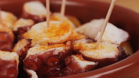 Octopus cooking, chef grill fresh octopus galician style on restaurant kitchen, healthy food, seafood cafe in spain, traditional asian japanese spanish and mediterranean dish.