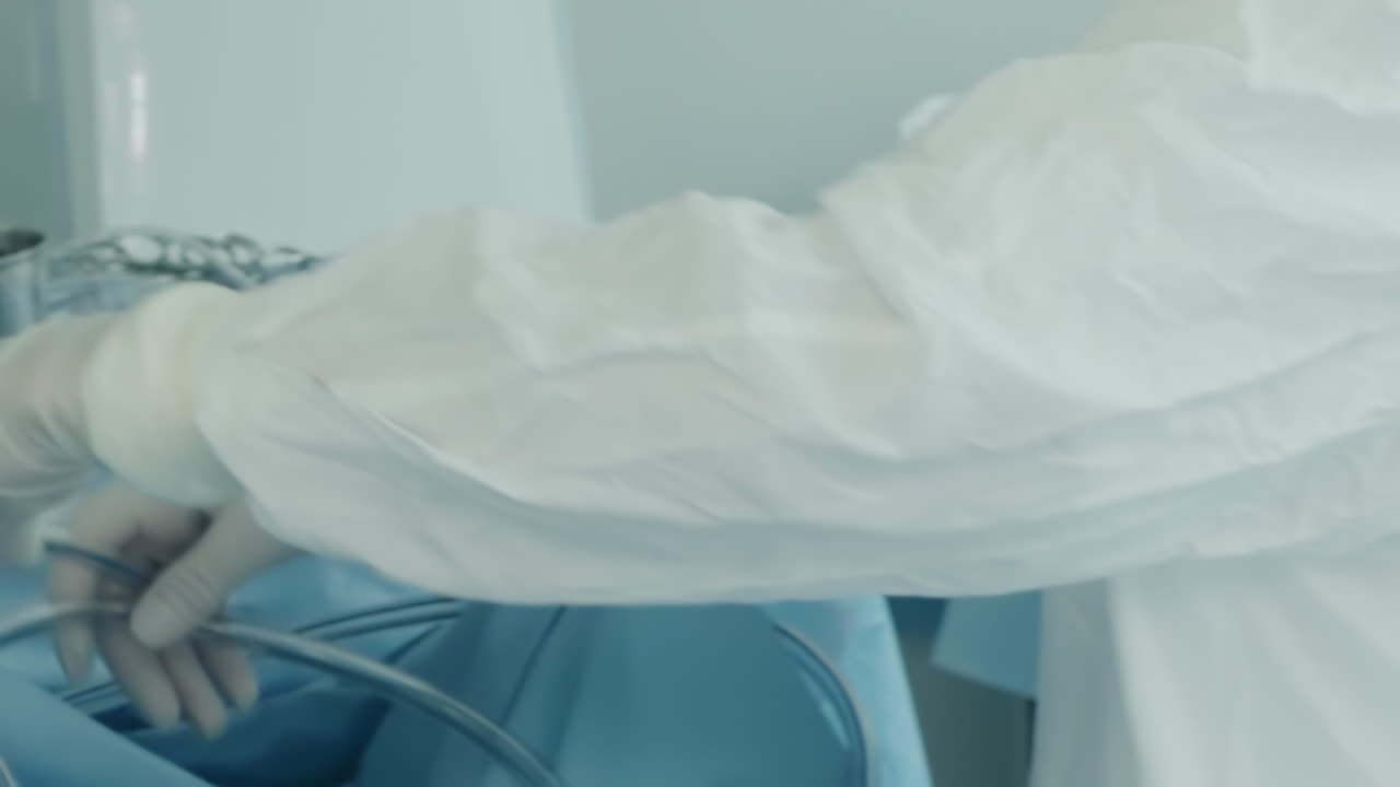 Nurse organizes tubes for heart surgery. Worker ensures all necessary equipment ready for coronary artery bypass procedure in hospital operating room