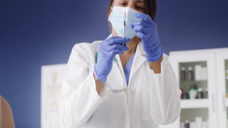 Handheld-video-of-female-doctor-giving-shot-to-patient