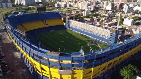 Aerial-wide-shot-of-Bombonera-Stadium-and-Skyline-of-Buenos-Aires-in-Background-at-sunset-Argentina