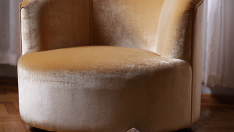 golden velvet armchair in an interior setting