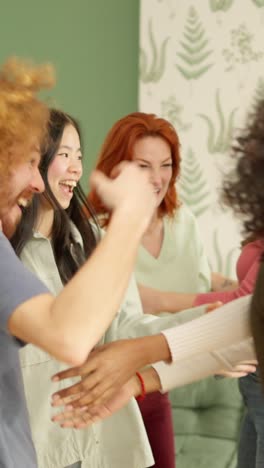 meeting of diverse friends embracing together at home
