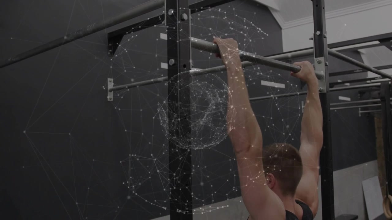 Vertical video: Gripping rack pullup bar, man in black top pulling for strength at gym, copy space