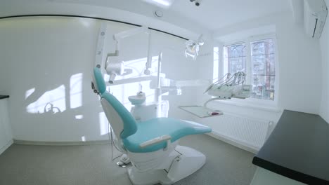 modern dental practice. dental chair and other accessories used by dentists in blue, medic light. fisheye