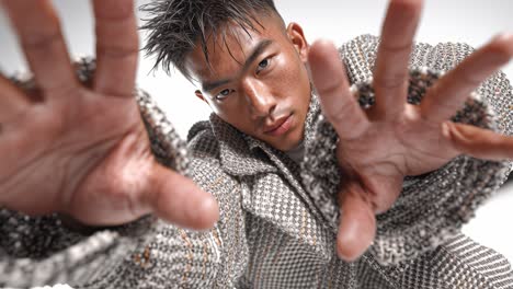 stylish man performing modern dance moves in slow motion on white background