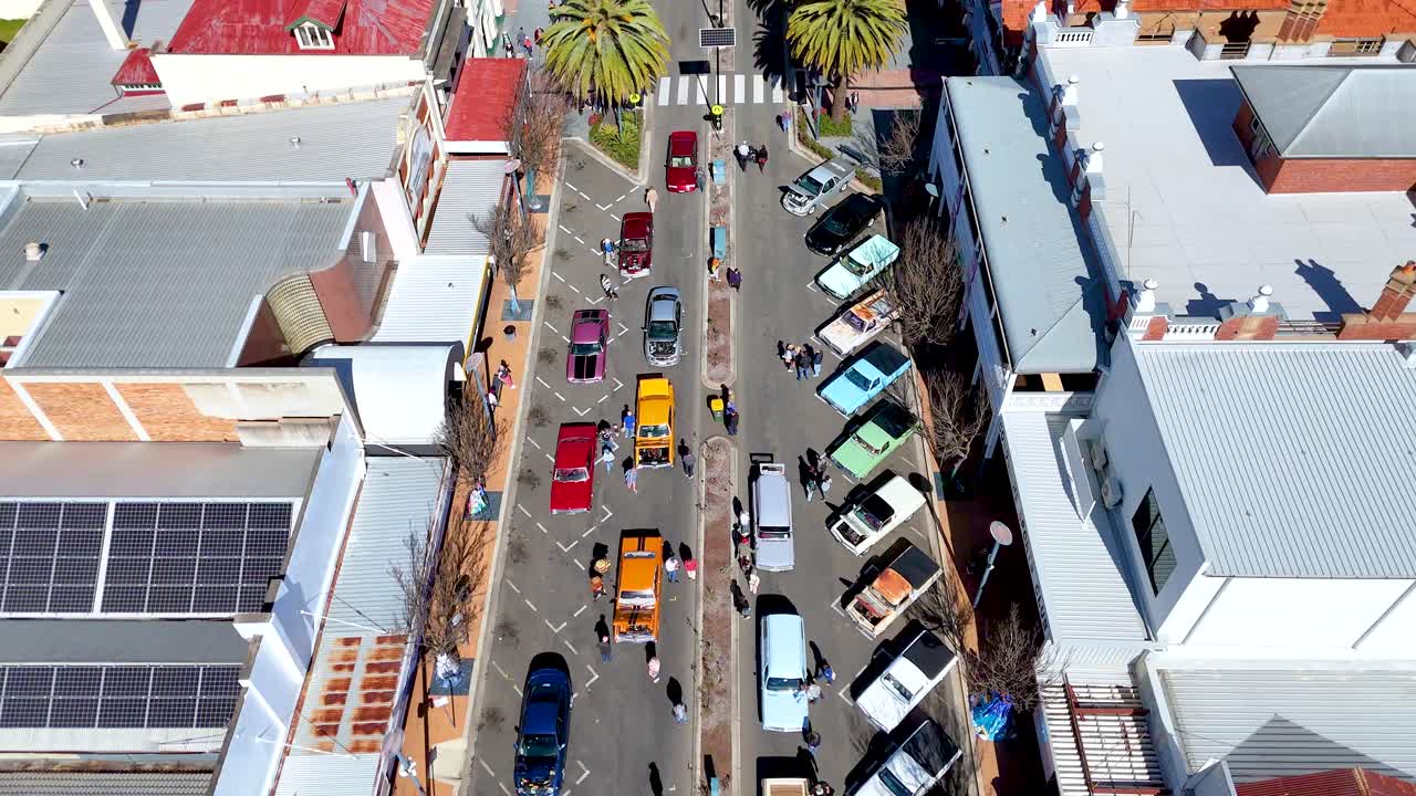 Colorful cars and crowds gather for lively street festival