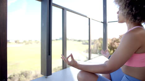 meditating on balcony, woman in sportswear practicing mindfulness and relaxation, copy space