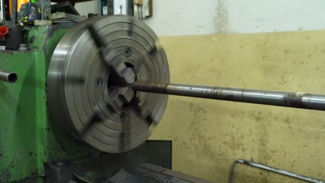la fibra metálica está girando alrededor del gran taladro de acero motor de máquina de torno metálico, fabricante de tecnología en proceso de operación en la fábrica de plantas de fabricación de la industria. equipos de productos crudos en el almacén.