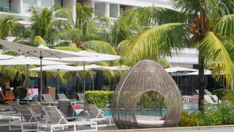 sun loungers and swimming pool at renaissance bali uluwatu resort and spa in bali, indonesia