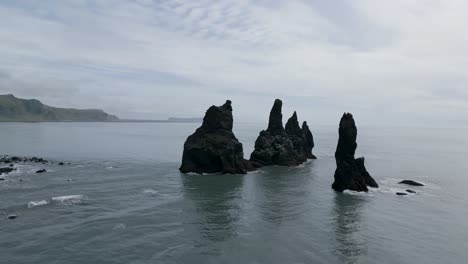 Flying-On-Rock-Formation-At-Black-Sand-Beach