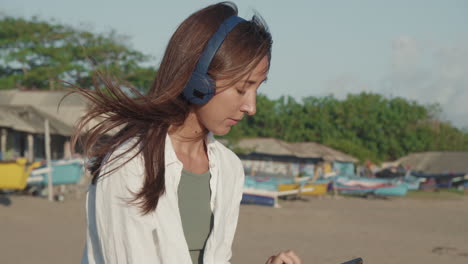 happy woman using gadget on beach