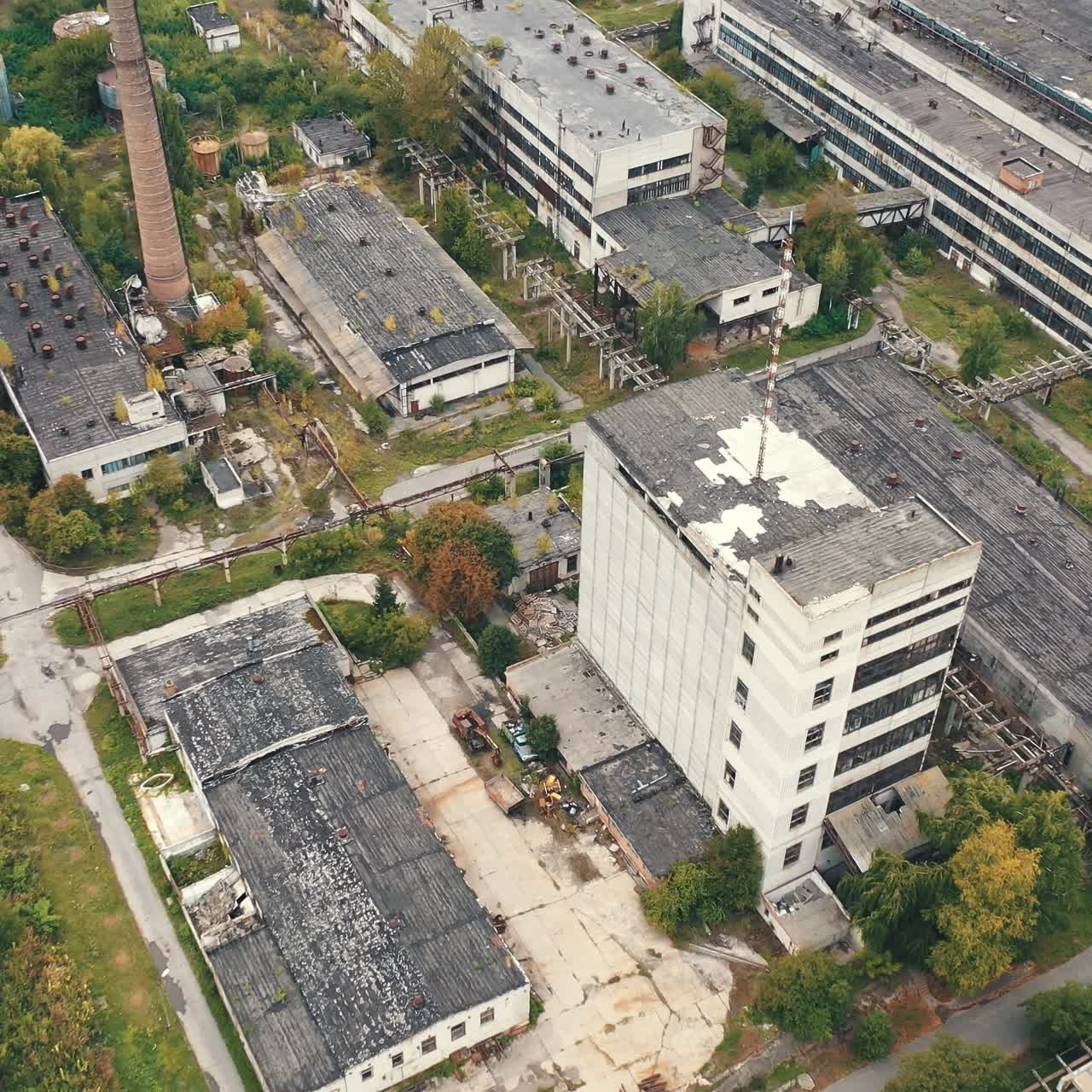 Aerial view of industrial destroyed city buildings. View from above of ruined and abandoned factory