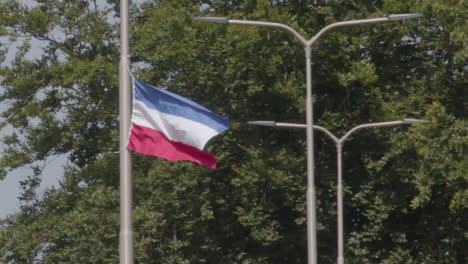 upside down dutch flag hanging on streetlight