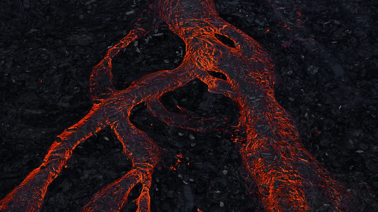 Streams of red hot lava flowing during a volcano eruption, aerial shot