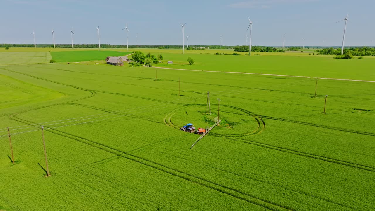 Aerial shot of agriculture machinery at work on Latvia, Grobina farmland, summer