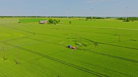 aerial shot of agriculture machinery at work on latvia, grobina farmland, summer